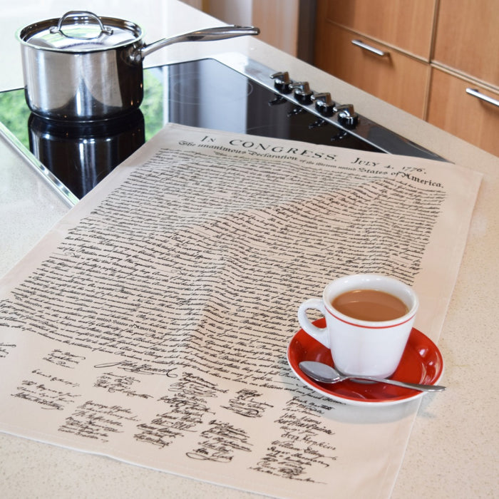 Kitchen counter with a tea towel featuring the U.S. Declaration of Independence and a cup of tea