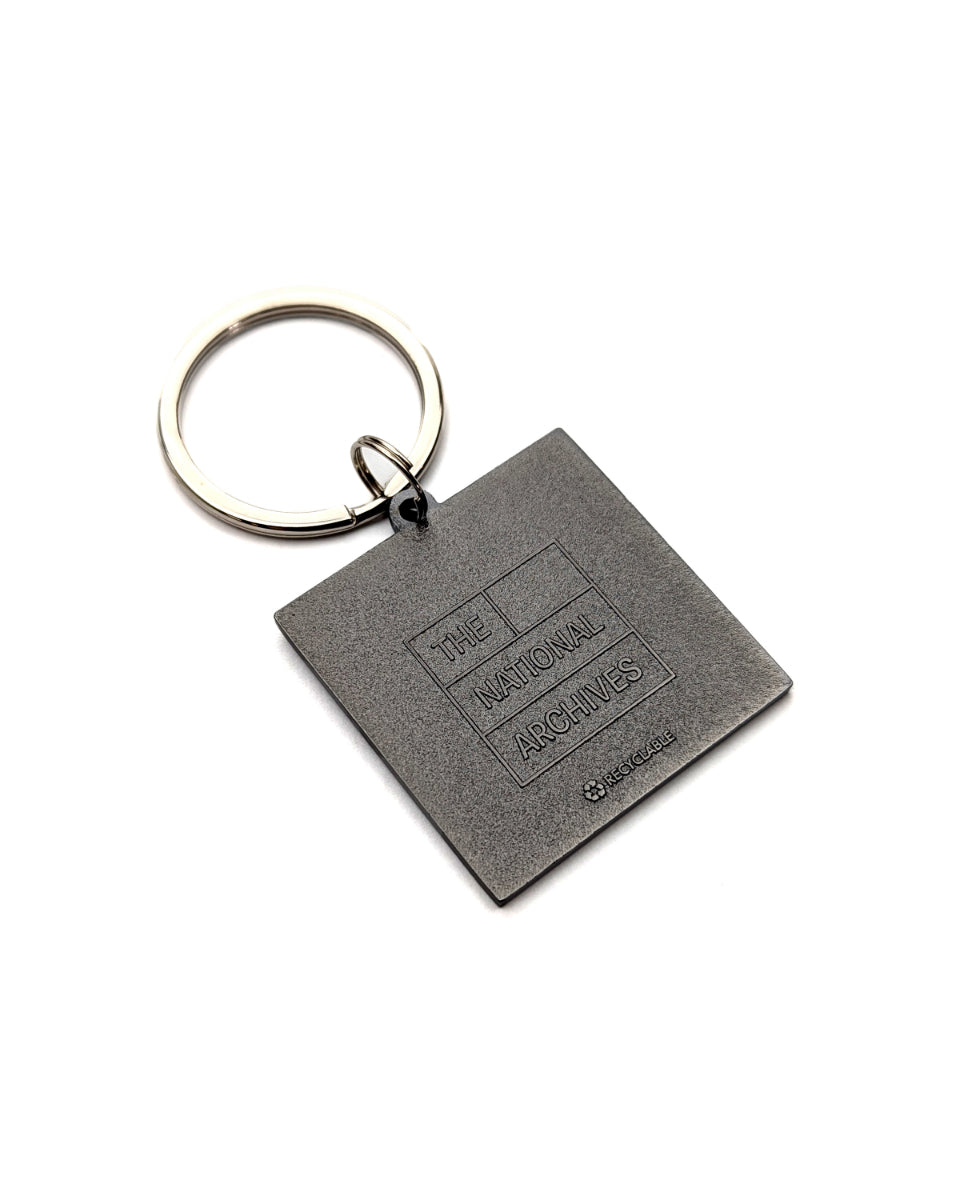 Keychain reverse with a textured dark gray finish, featuring an embossed logo that reads 'THE NATIONAL ARCHIVES' 