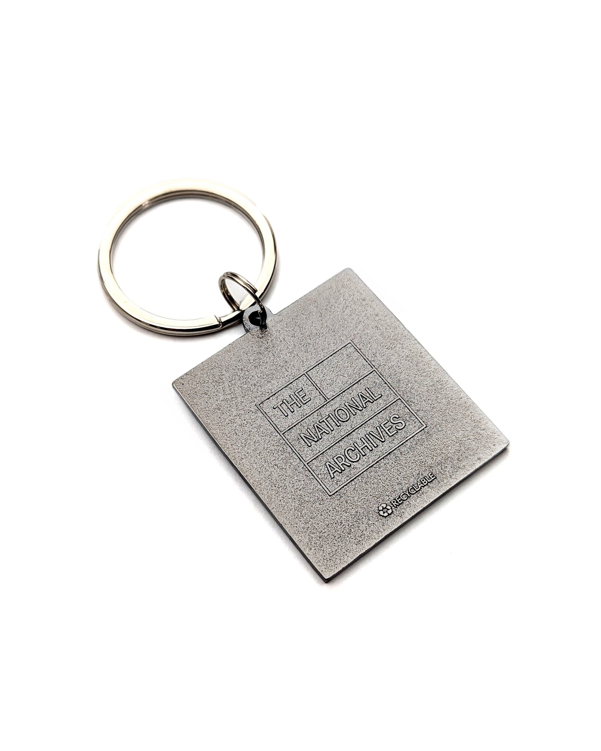 A square metal keychain reverse featuring a textured silver-gray pendant engraved with 'THE NATIONAL ARCHIVES' 