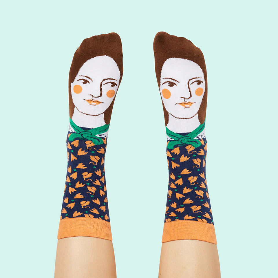 Pair of socks with a design of a woman's face on a light blue background