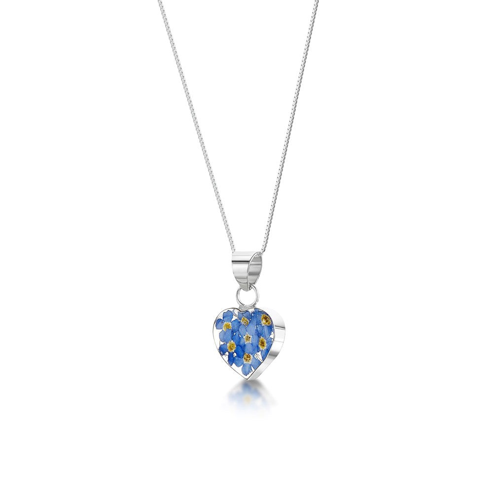 A silver heart-shaped pendant necklace featuring a pattern of blue and yellow flowers, suspended from a delicate silver chain against a white background.
