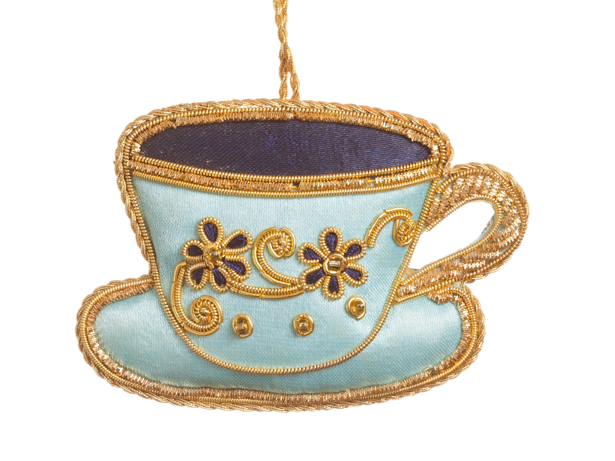 Decorative fabric ornament shaped like a teacup with gold trim on a white background