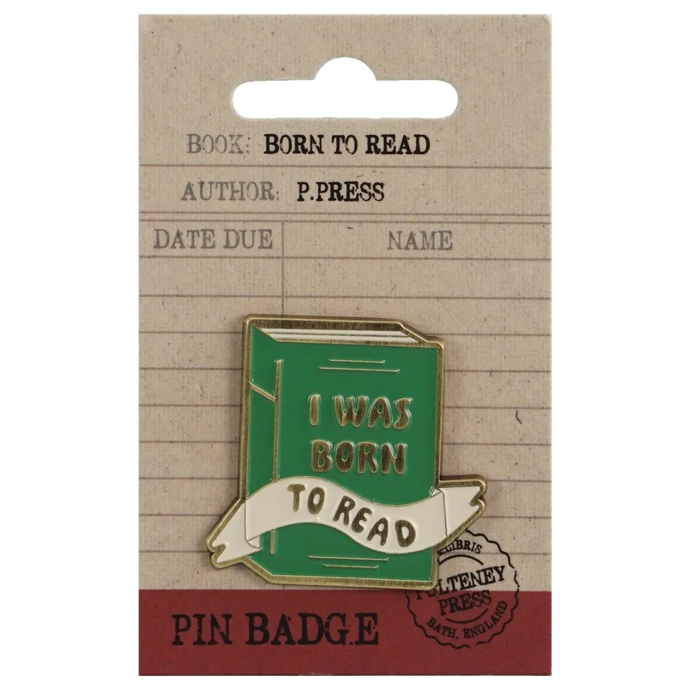 Pin badge with 'I was born to read' design on a book-shaped card, displayed on a cardboard backing.