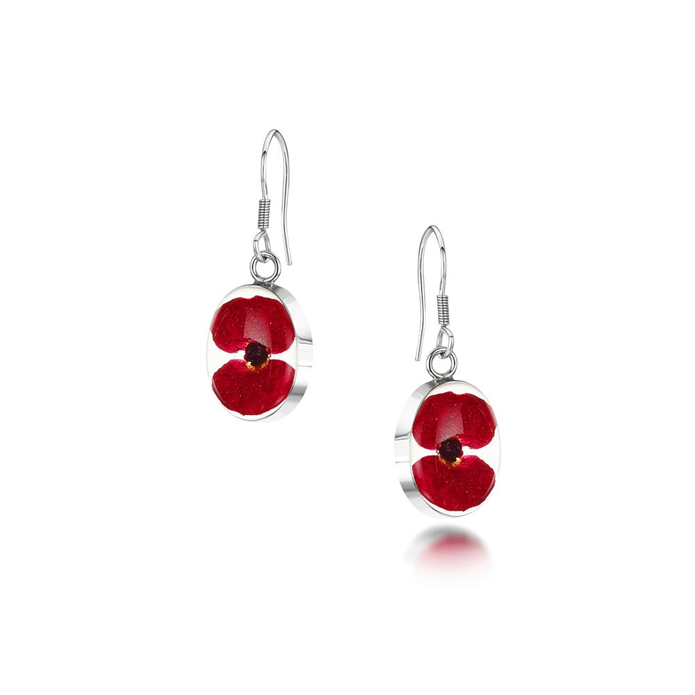 Silver drop earrings featuring a red pressed poppy flower encased in clear resin.