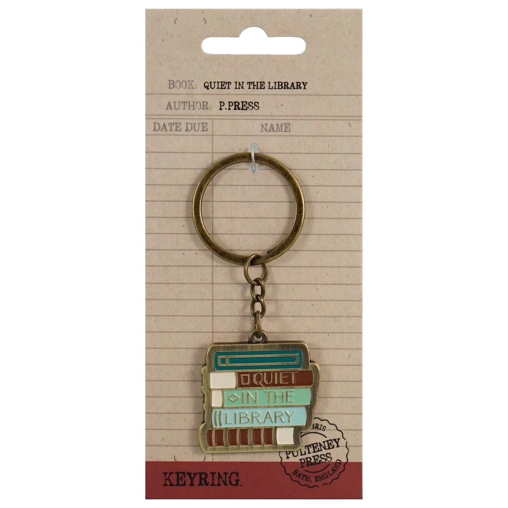 A book-themed keyring charm on a kraft paper hanger card. The keyring features stacked books with the words 'QUIET IN THE LIBRARY' 