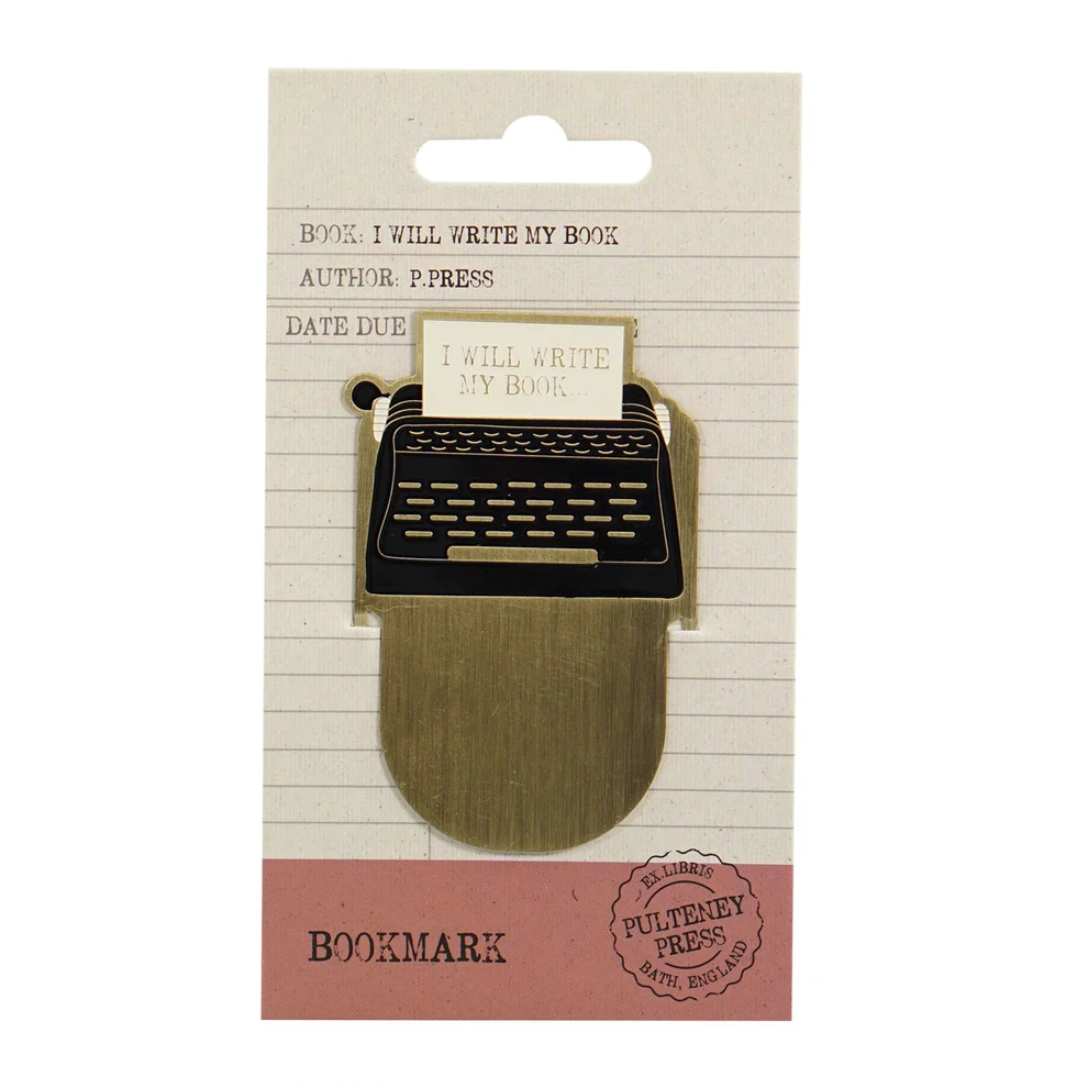 A typewriter-shaped bookmark featuring a gold-toned metal typewriter with a black keyboard and a small paper slot that reads 'I WILL WRITE MY BOOK'. 