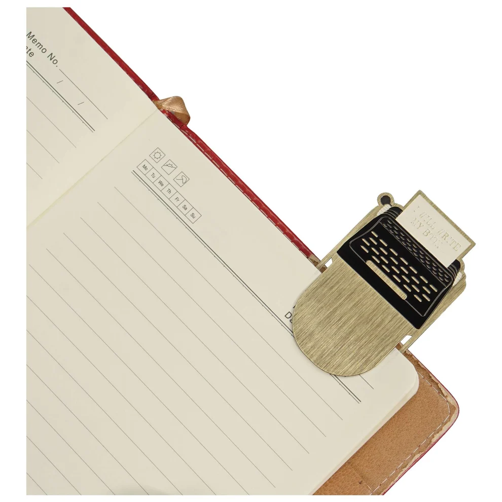Image of typewriter shaped metal bookmark in use