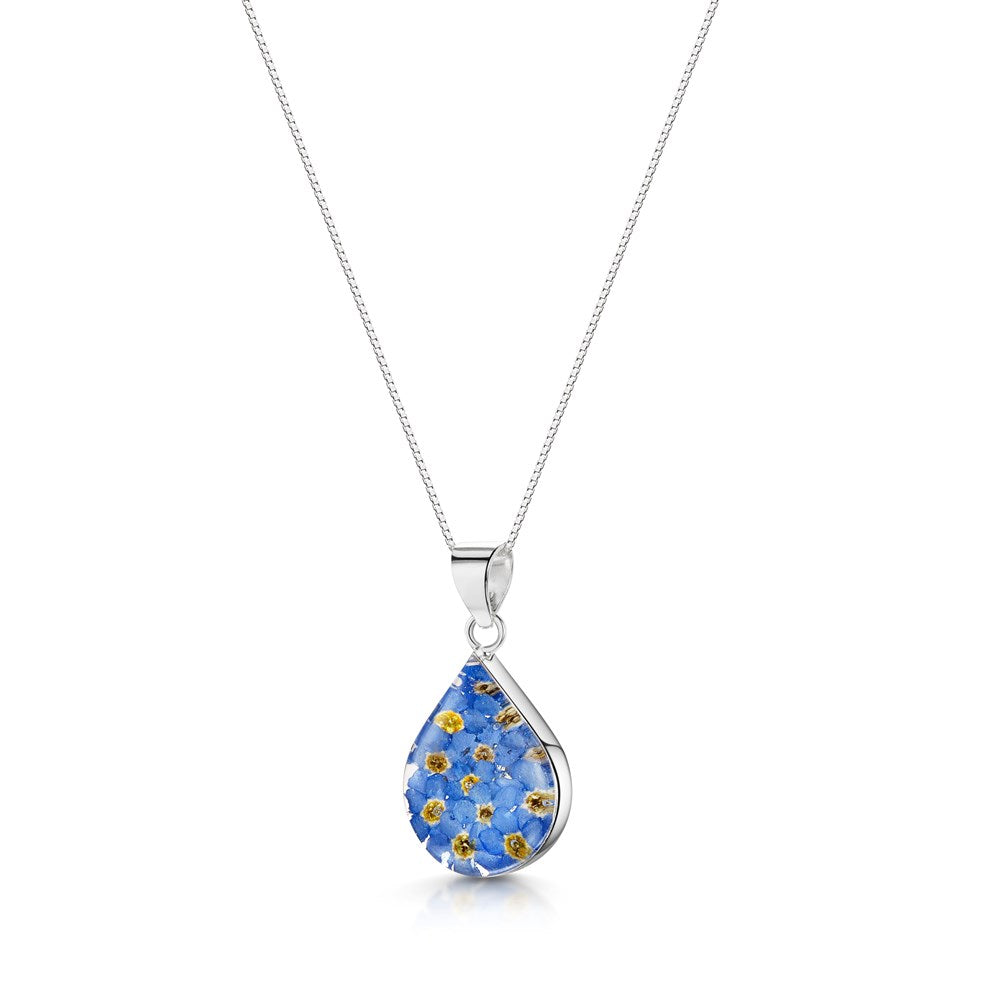 A silver teardrop pendant necklace featuring a floral inlay of small blue flowers with yellow centers, suspended from a delicate silver chain against a white background.