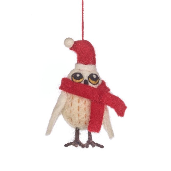 Felt owl ornament wearing a red scarf and Santa hat on a white background